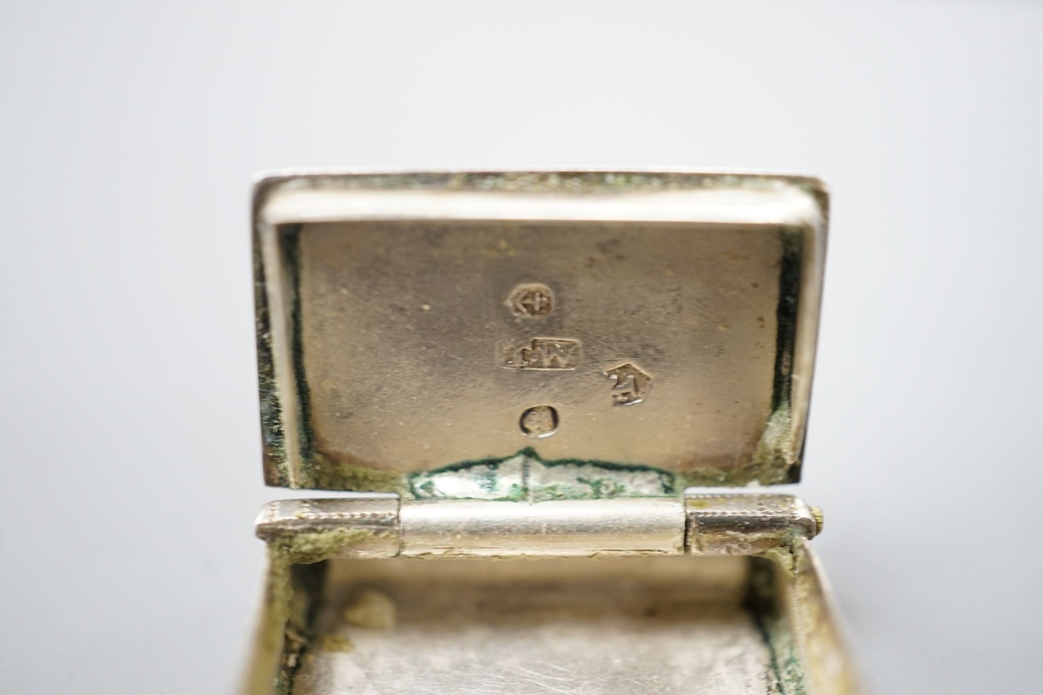 A George IV novelty silver vinaigrette, modelled as a handbag, Gervase Wheeler, Birmingham, 1832, 27mm(handle at one end detached), one other silver vinaigrette, Edward Smith, Birmingham, 1829 and a similar silver 'book'